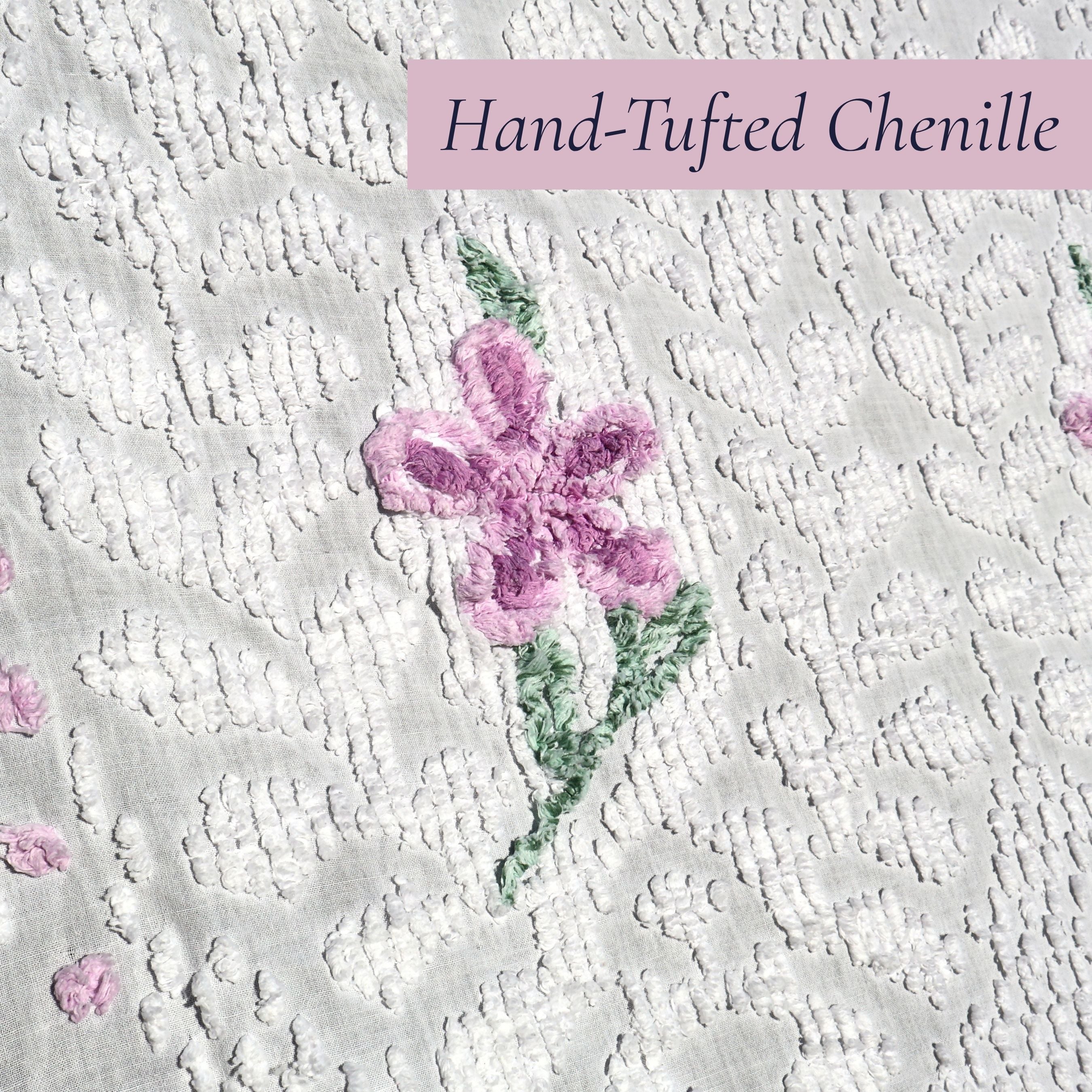Detailed view of an original hand-tufted lavender flower on a vintage white chenille bedspread. The soft raised chenille texture showcases classic vintage craftsmanship and makes this heirloom textile ideal for cottagecore decor, farmhouse homes, and romantic bedroom styling.