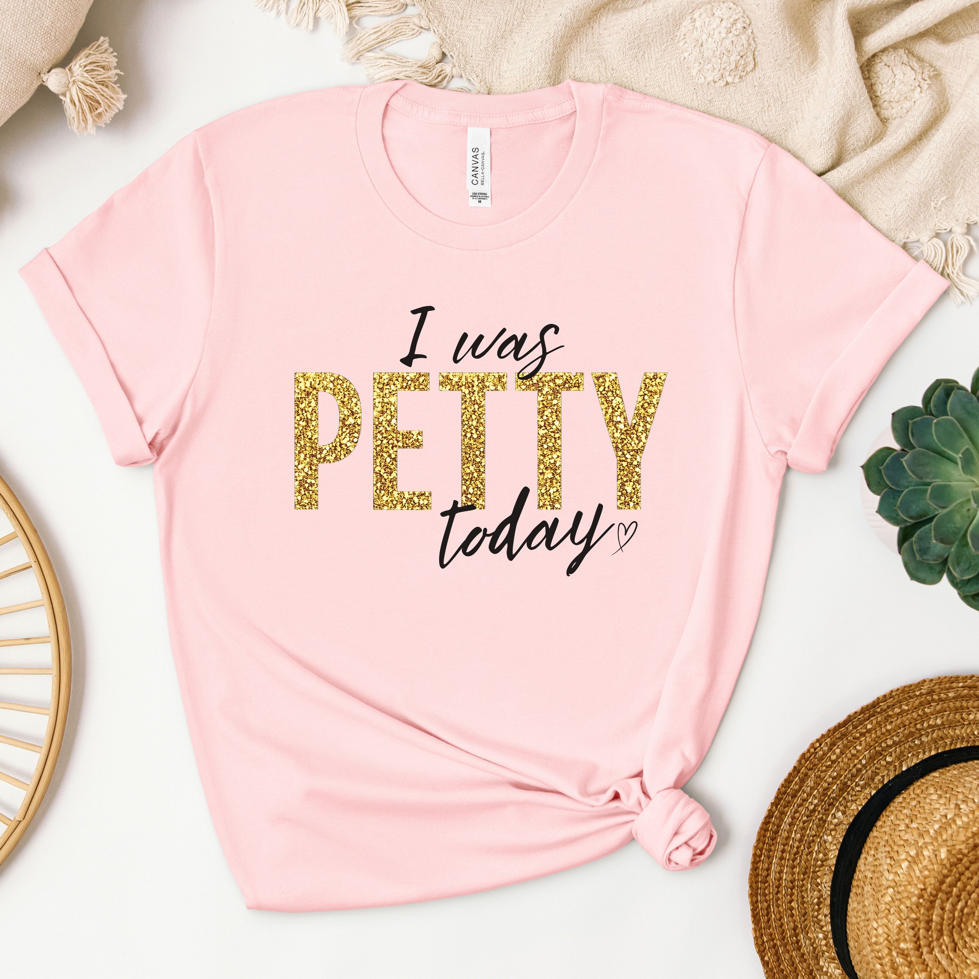 Light pink “I Was Petty Today” gold faux glitter graphic tee, feminine flat lay mockup, funny sarcastic shirt for women, trendy soft color boutique clothing