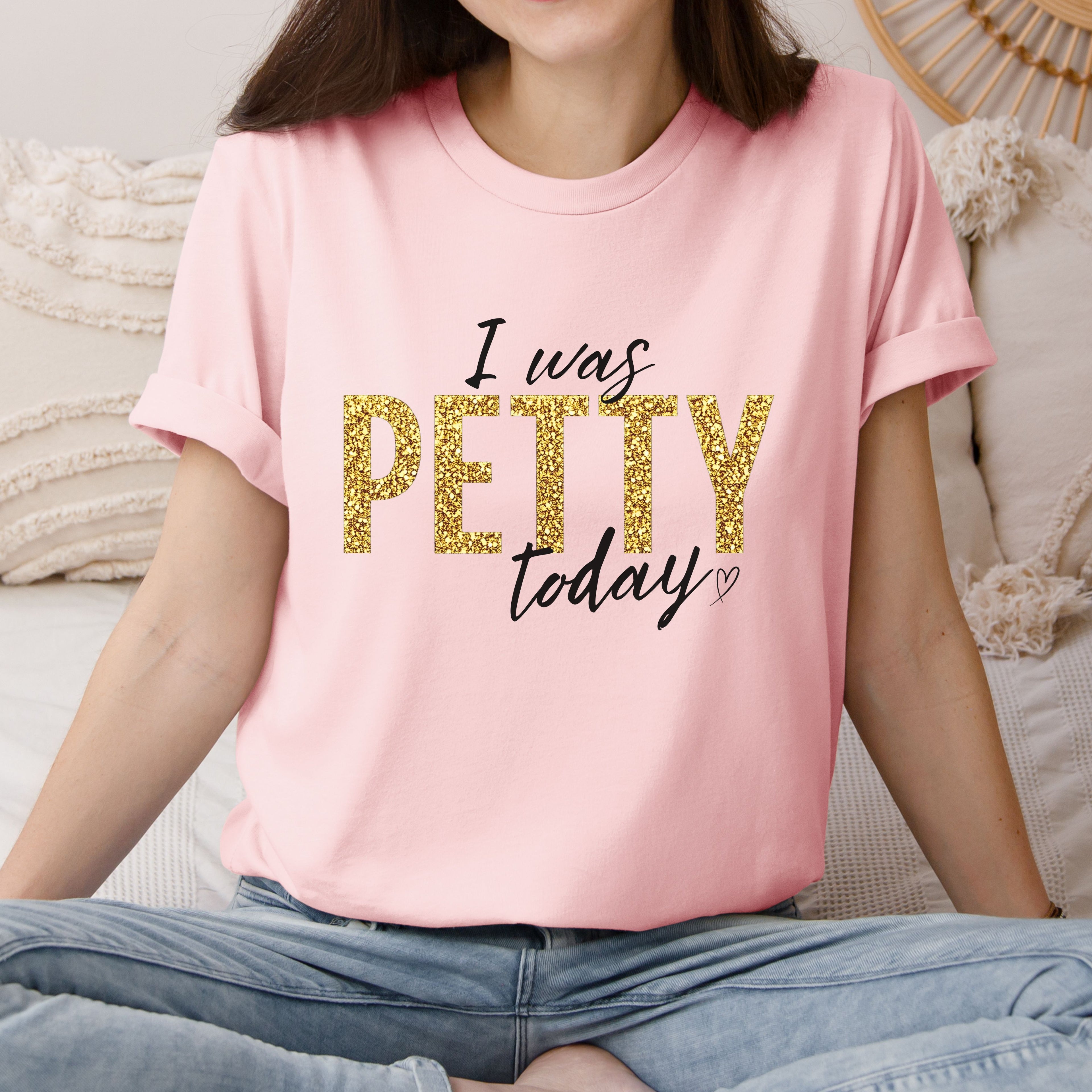 Woman wearing soft pink “I Was Petty Today” gold faux glitter shirt, feminine casual outfit, funny sarcastic graphic tee for women, trendy boutique apparel