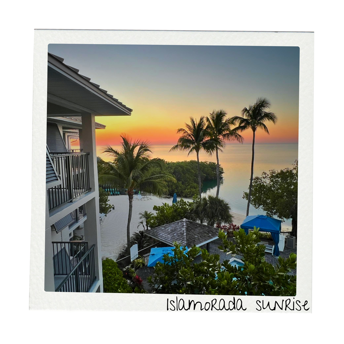 Polaroid-style travel photograph of a colorful sunrise over the ocean in Islamorada, Florida, framed by palm trees and a waterfront resort in the Florida Keys. The handwritten caption reads Islamorada sunrise and supports the travel-inspired Beach Days Collection.