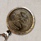 back view of 2004 Jefferson nickel featuring Louisiana Purchase Westward Journey design, hands exchanging tools engraved on authentic US coin pendant, sterling silver framed vintage necklace for collectors and history inspired jewelry lovers