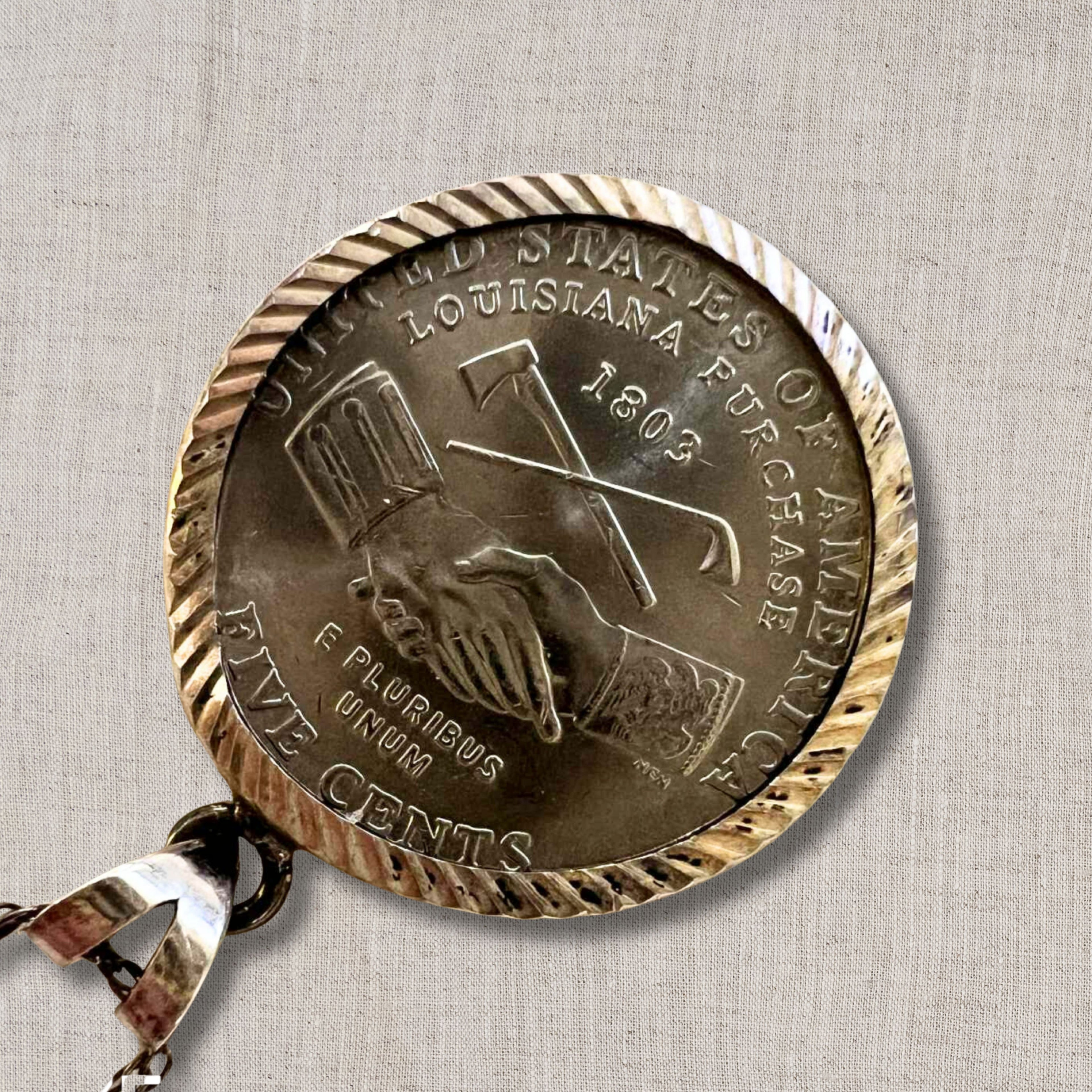 back view of 2004 Jefferson nickel featuring Louisiana Purchase Westward Journey design, hands exchanging tools engraved on authentic US coin pendant, sterling silver framed vintage necklace for collectors and history inspired jewelry lovers