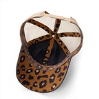 Interior view of washed black women’s trucker hat showing leopard print underbrim and coordinating seam tape detail