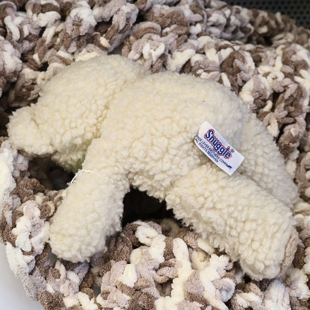 Rear view of the vintage Snuggle plush showing thick sherpa-style fabric and the original Lever Brothers sewn copyright tag. A collectible advertising mascot from the mid-1980s that displays beautifully in laundry rooms, vintage toy collections, or nostalgic home decor.