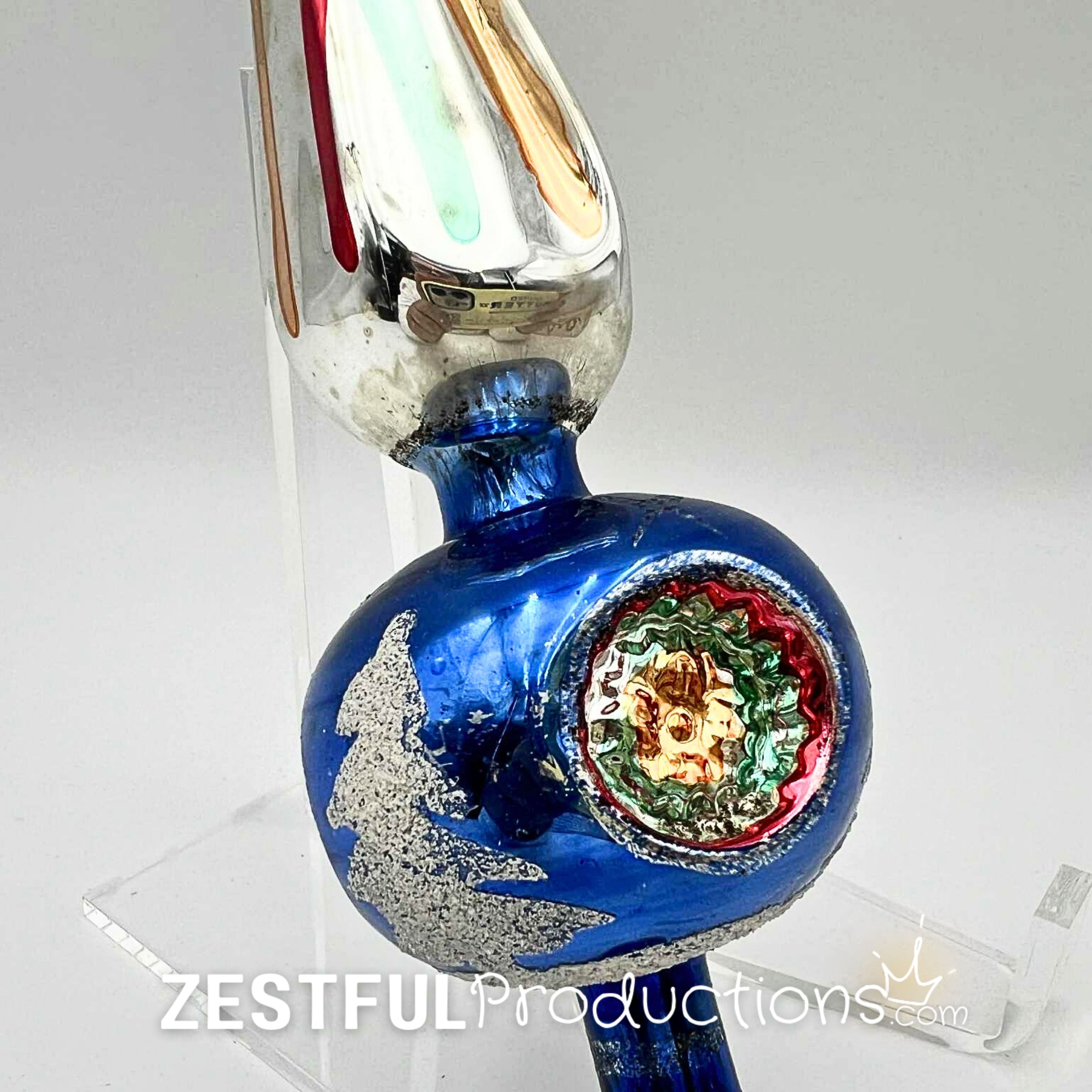 Detailed close-up of vintage blue mercury glass Christmas tree topper with indented reflector center and silver accents, showcasing retro mid century holiday ornament artistry.