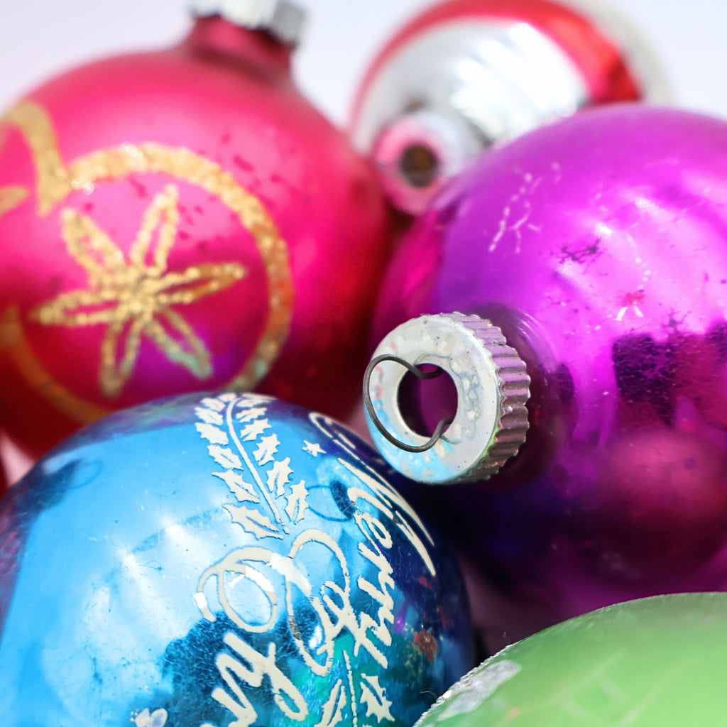 Detailed view of colorful vintage Christmas ornaments featuring mercury glass finishes and nostalgic retro holiday decor