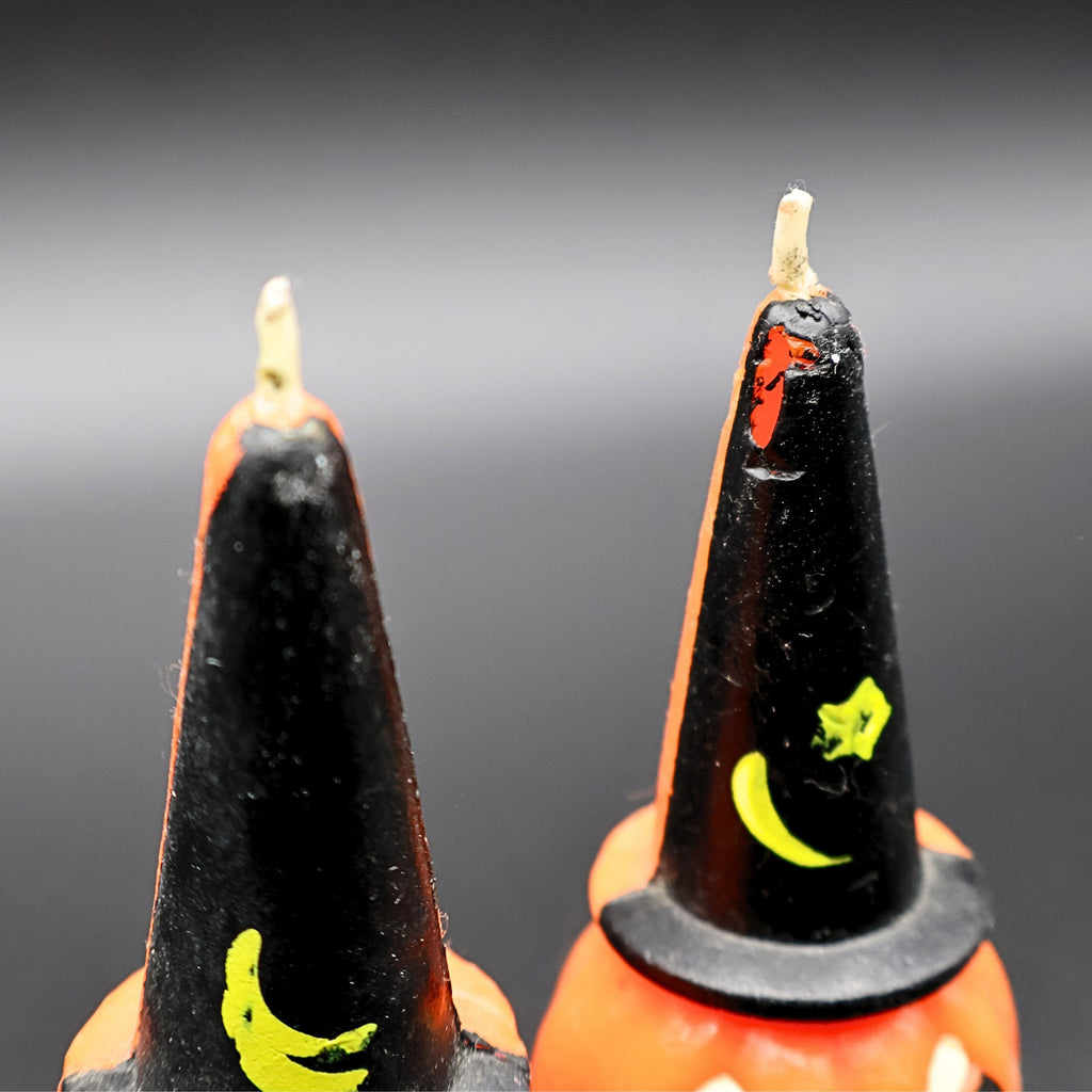 Detailed view of vintage Gurley Halloween pumpkin candles with black witch hats, unused condition detail