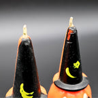 Detailed view of vintage Gurley Halloween pumpkin candles with black witch hats, unused condition detail