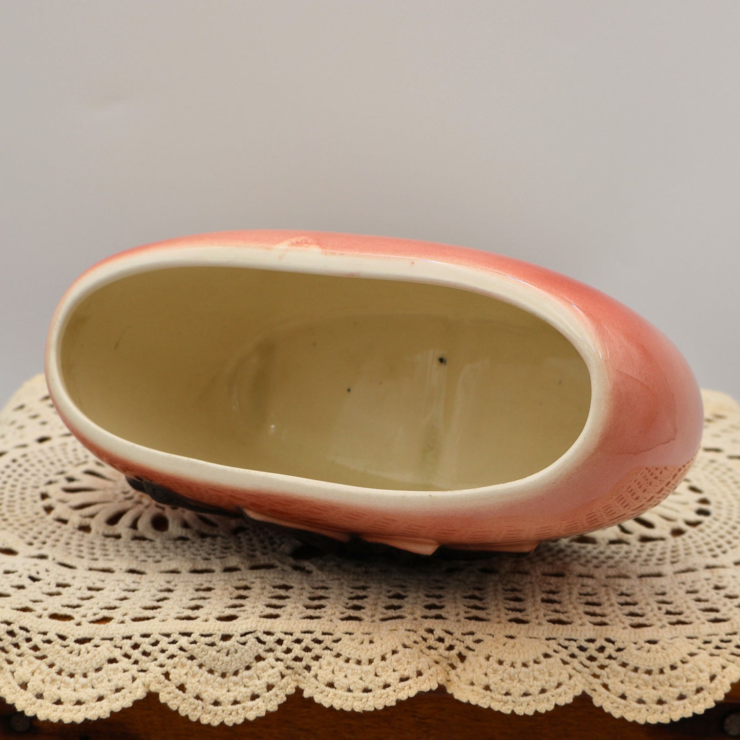 Top opening of vintage Royal Copley pink planter with oval shape and smooth cream rim.