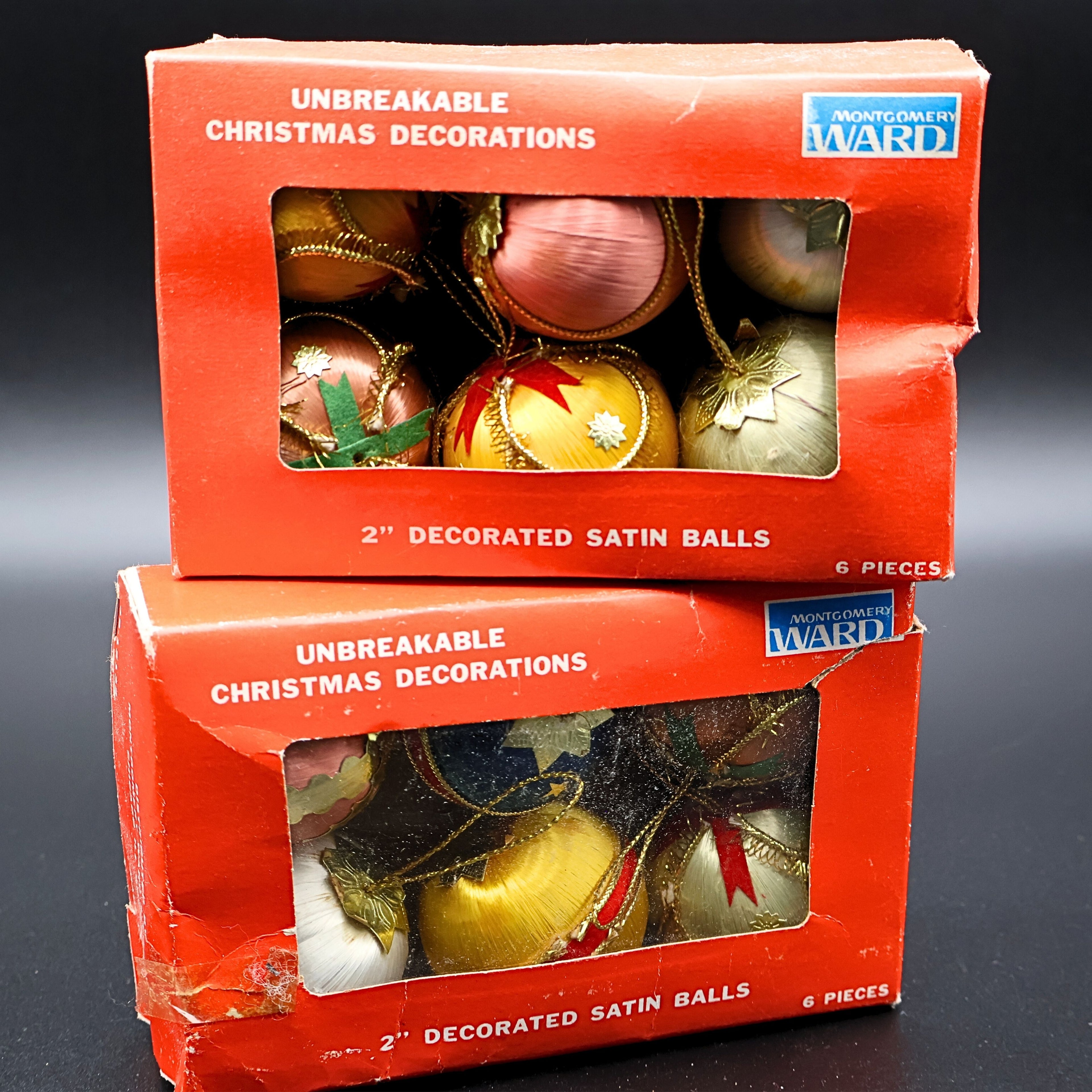 Vintage Montgomery Ward unbreakable Christmas decorations box with satin ornaments inside, featuring original packaging and retro holiday decor appeal for collectors and vintage Christmas styling