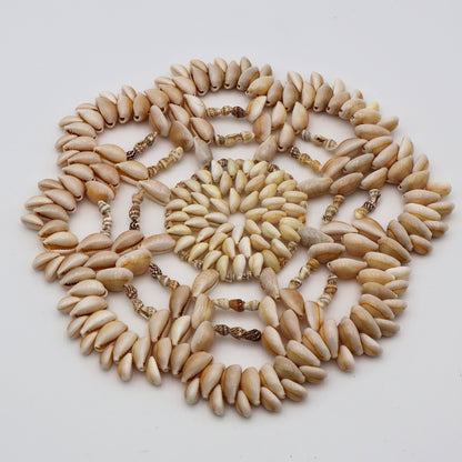 Vintage 1970s beach style seashell hot pad with textured layered design