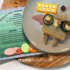 owl-shaped sandwich kids recipe from Oliver the Owl children’s cookbook with cucumber eyes and cheese beak on plate