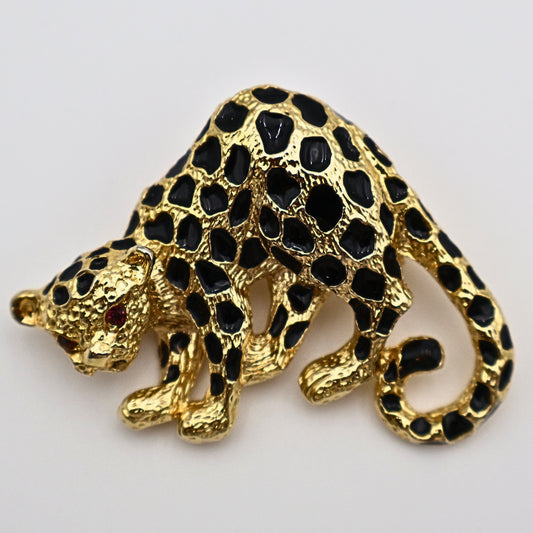 Vintage Park Lane cheetah brooch pin in gold-tone metal with black enamel spots and red rhinestone eyes