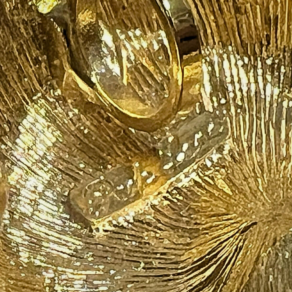 Close-up of Park Lane maker mark on cheetah brooch