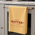 Personalized unsalted butter microfiber tea towel hanging on oven handle in modern neutral kitchen with red butter wrapper inspired typography and tablespoon measurement markings. Funny baker gift dish cloth for chefs, cooking lovers and quirky kitchen decor enthusiasts.