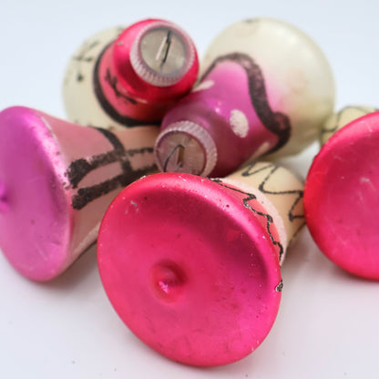Closeup of pink mercury glass ornament bottoms showing authentic vintage wear and mid century Christmas styling