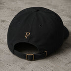 Back view of black embroidered Poopenfarten Motorwerke cotton dad cap featuring adjustable brass buckle strap and rear PF logo embroidery.