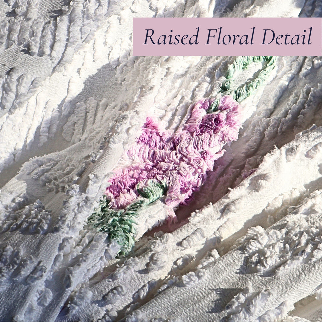 Raised lavender floral tufting on a vintage white chenille bedspread highlights the dimensional texture and exceptional craftsmanship. Perfect for cottage decor, farmhouse bedding, shabby chic interiors, romantic bedrooms, and vintage textile enthusiasts.