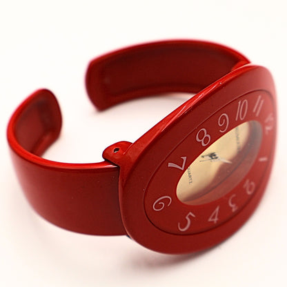 Side view of red cuff watch with chunky bracelet design, vintage 90s statement watch with curved bangle fit and glossy red finish
