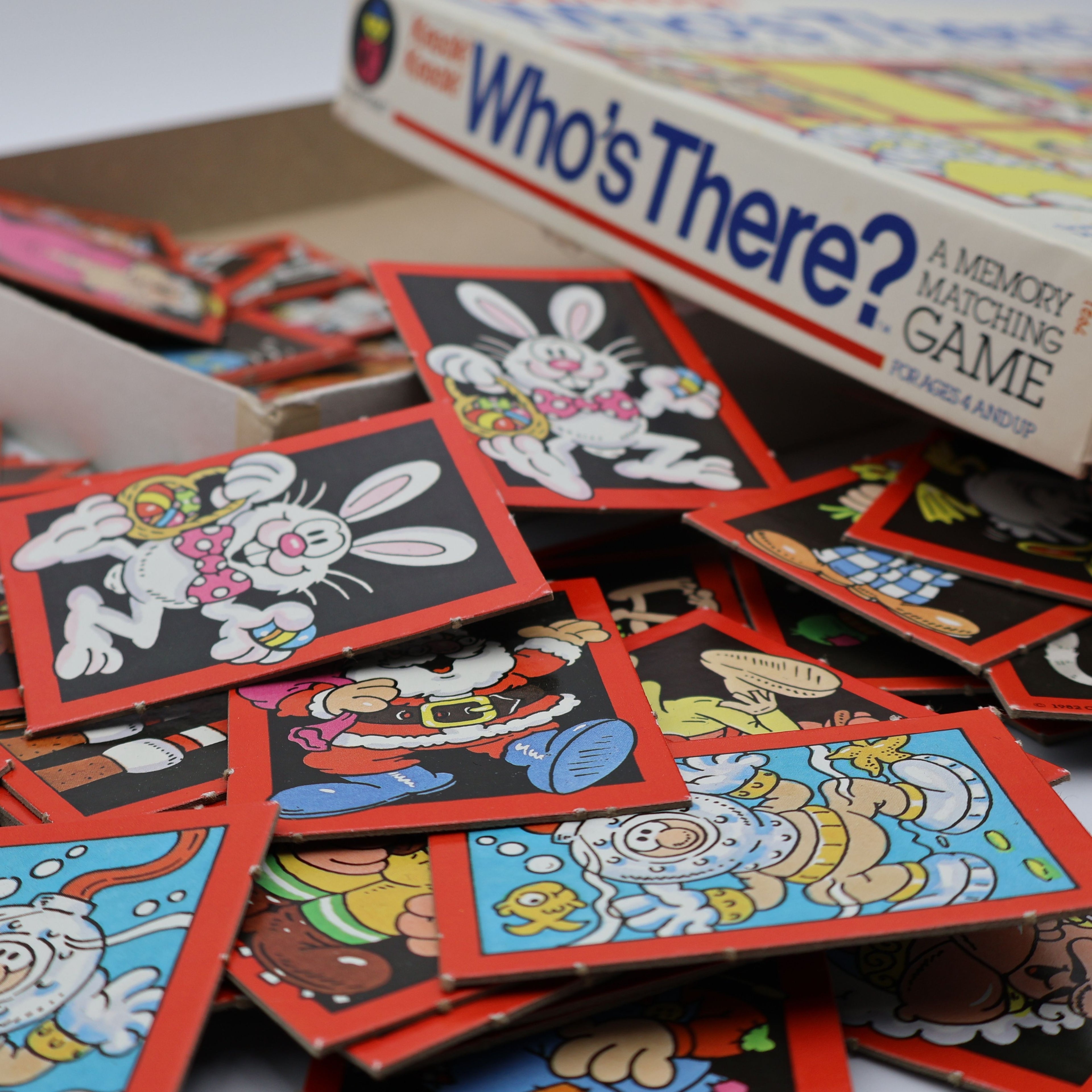 Side angle view of vintage 1982 Colorforms Knock Knock Who’s There memory game box with matching cards in foreground.