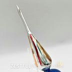 Side profile of vintage handblown mercury glass Christmas tree topper featuring elongated finial point with red, gold, and green accents in authentic 1960s retro holiday style.
