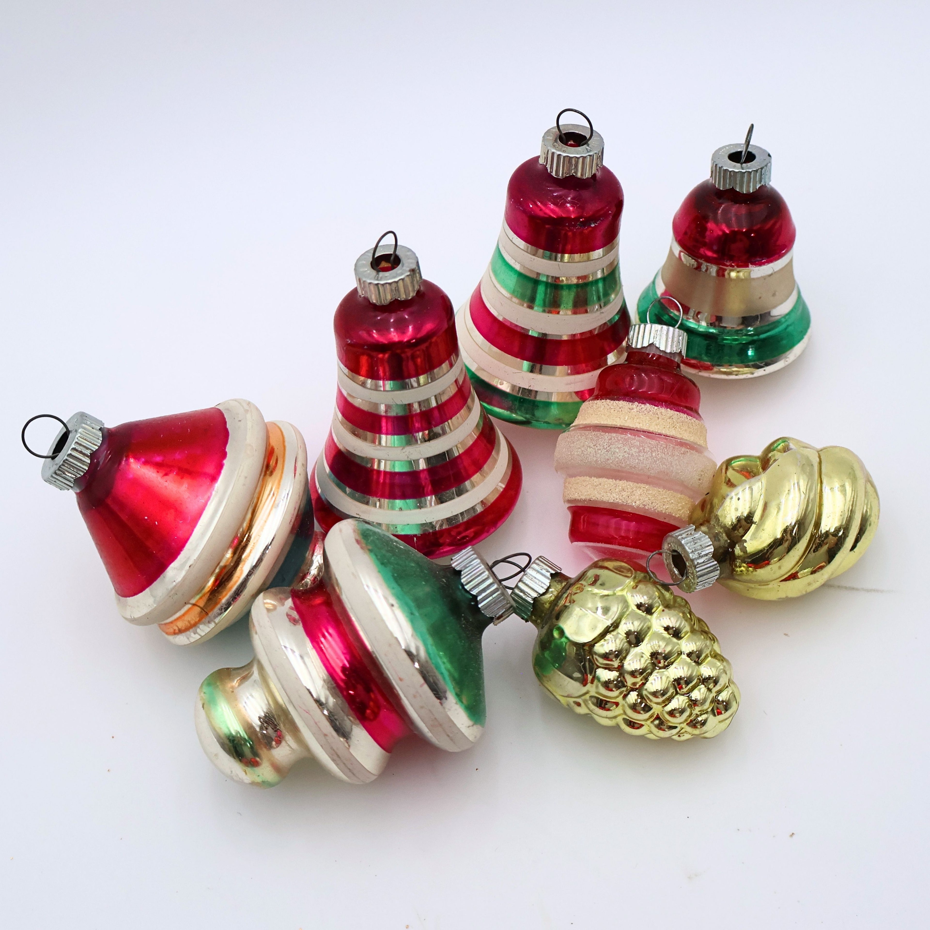 Vintage mercury glass Christmas ornaments with striped lantern shapes and reflective retro holiday finishes