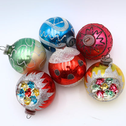 Vintage reflector indent ornaments featuring atomic era Christmas styling and jewel tone mercury glass decoration