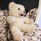 Side view of a vintage Snuggle fabric softener mascot plush showing soft textured fleece, raised arm pose, and classic smiling expression. A nostalgic 1980s advertising collectible perfect for display shelves, vintage toy collections, and lovers of iconic household brand memorabilia.