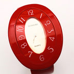 Rumours 29978 red cuff watch face showing stylized numbers and quartz movement dial, vintage bracelet watch with bold retro design and glossy finish