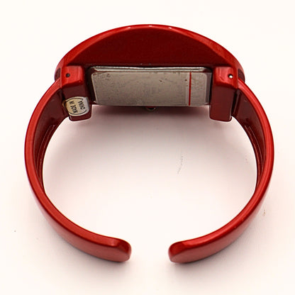 Back view of Rumours cuff watch showing quartz movement case and battery compartment, vintage bracelet watch interior with metal backing and red casing
