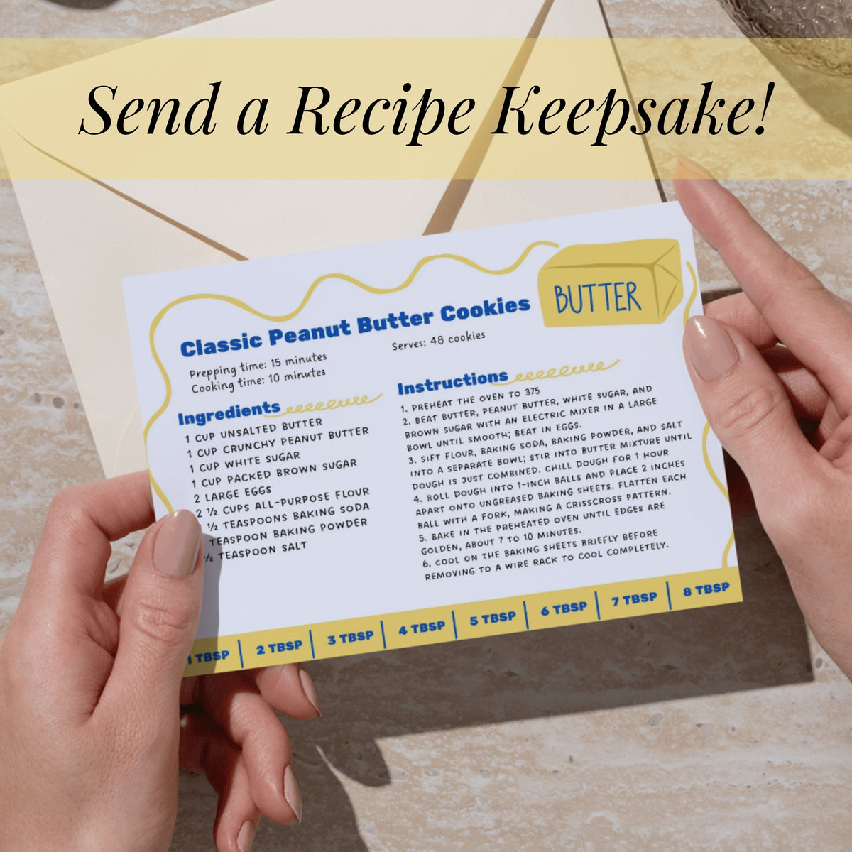 Person holding a completed blue-and-yellow Salted Butter recipe card featuring a classic peanut butter cookie recipe. The editable 4 x 6 inch Canva template offers a colorful way to preserve family recipes and share favorite baked treats.