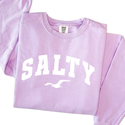 Orchid purple SALTY sweatshirt flat lay, oversized pastel crewneck sweatshirt, coastal beachwear for women, soft cotton blend sweatshirt, feminine seaside style, nautical graphic top