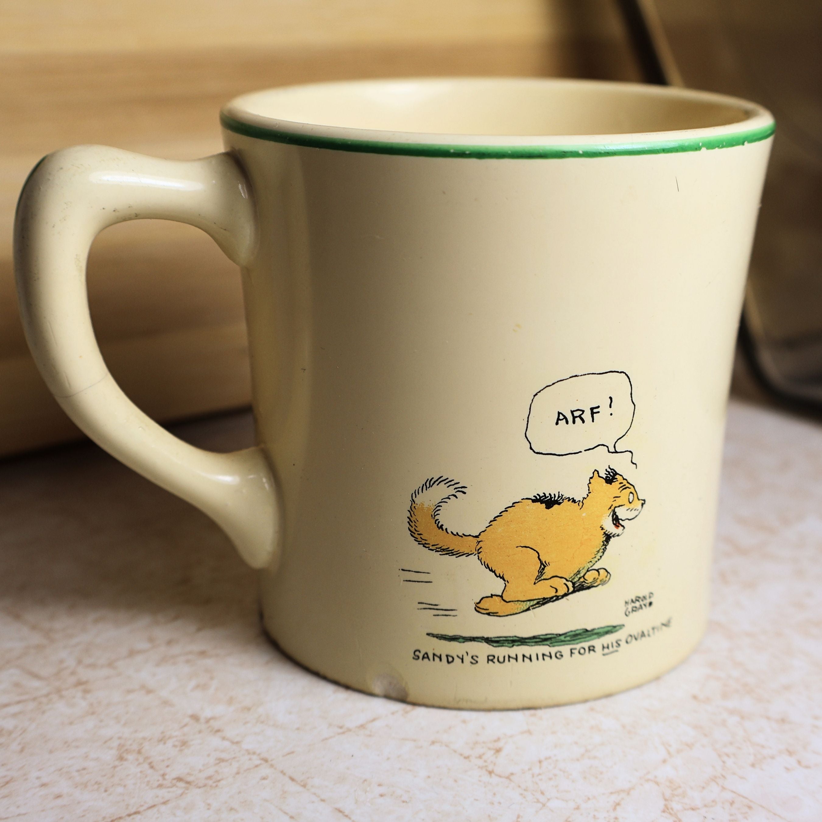 Reverse side of vintage Ovaltine mug featuring Sandy the dog running with the caption "Sandy's running for his Ovaltine."