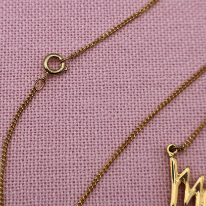 Close-up of spring ring clasp and gold tone chain on vintage Sarah Coventry Mary Kay necklace.