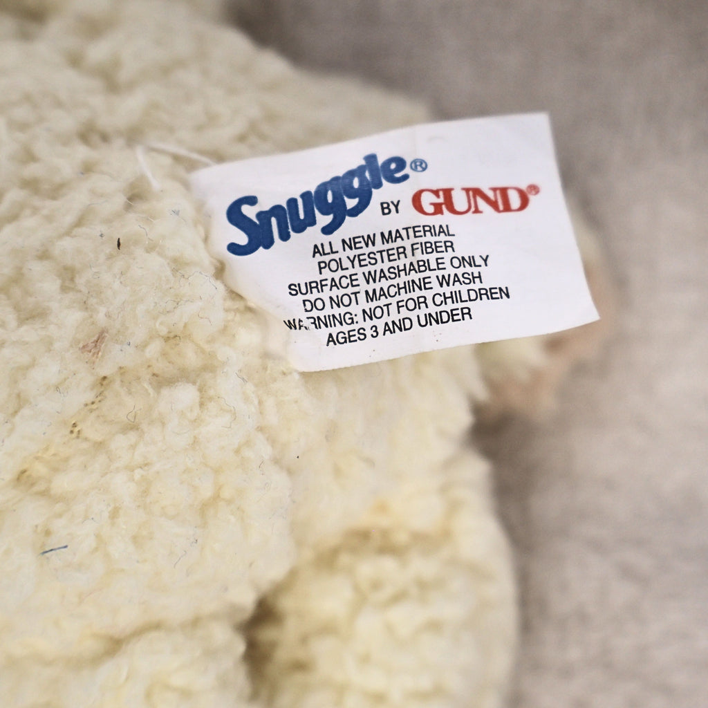 Close-up of the original Snuggle by GUND fabric tag attached to the vintage plush mascot. The label confirms licensed GUND production and helps authenticate this nostalgic advertising collectible for vintage plush collectors.