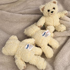Rear view of three vintage Snuggle by GUND plush bears displaying their original manufacturer labels. This image highlights authentic sewn tags and the overall condition of each collectible plush for vintage toy and advertising memorabilia buyers.