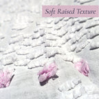 Macro photograph showing the luxuriously soft raised chenille texture on a vintage white bedspread with lavender floral accents. Beautiful for farmhouse decor, cottage bedrooms, heirloom bedding collections, vintage textiles, and romantic interior decorating.