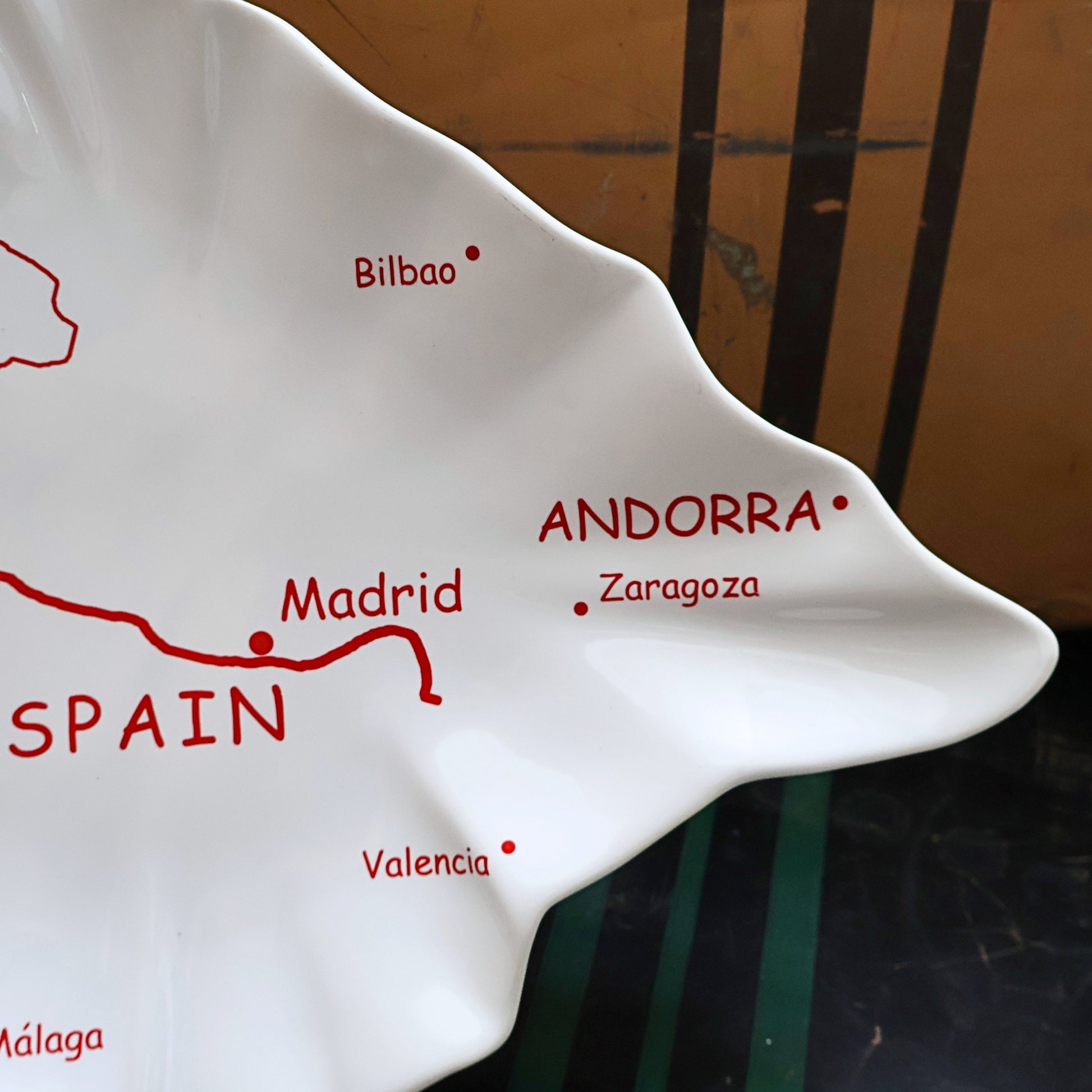 Closeup of vintage Spain map ceramic tray showing Andorra Zaragoza and Madrid graphics, glossy white Spain shaped serving platter, Mediterranean tapas tray, European travel souvenir decor, collectible ceramic dish