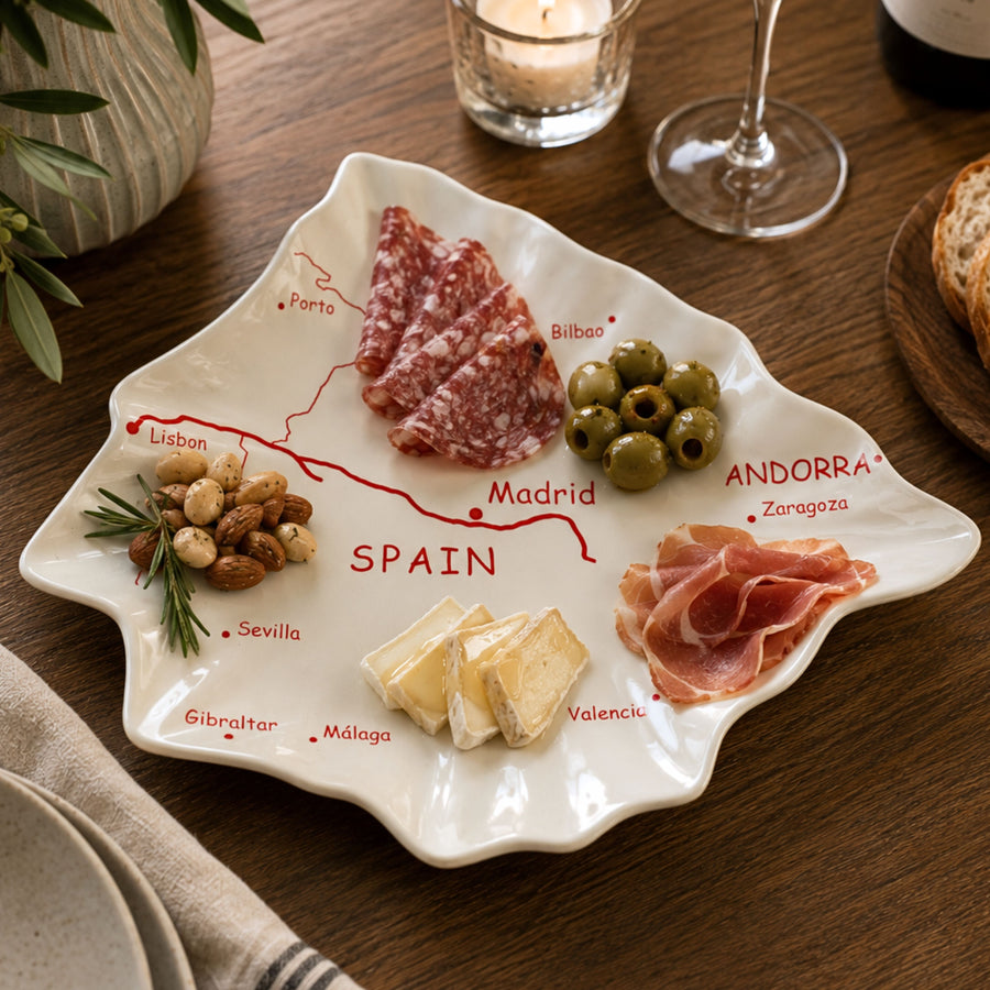 Vintage Spain map ceramic serving platter styled with charcuterie meats cheese olives and wine glasses, Mediterranean tapas tray, Spain shaped serving dish, European travel inspired entertaining decor, glossy white ceramic platter