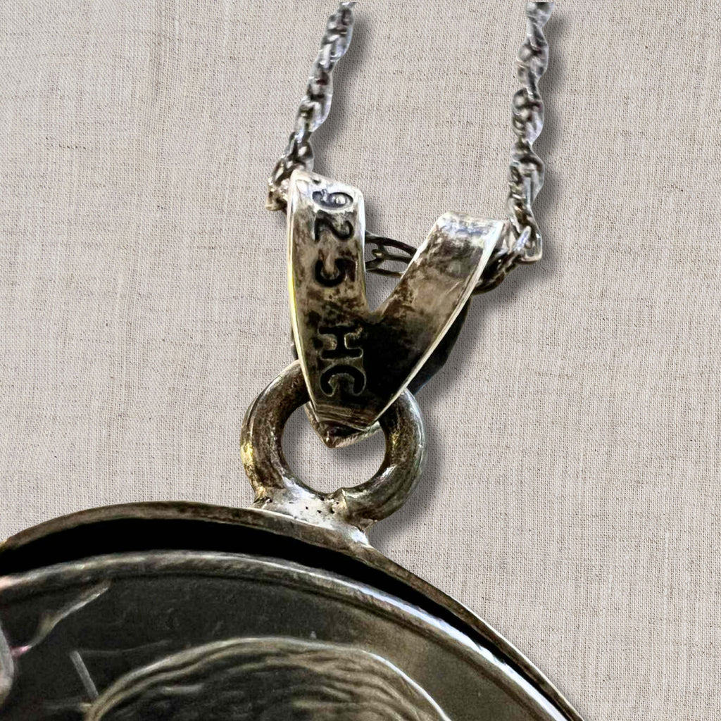 close up of sterling silver bail on Jefferson nickel coin pendant necklace showing 925 stamp, vintage coin jewelry craftsmanship detail with attached chain, authentic US currency pendant setting with aged patina