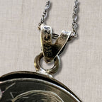 close up of sterling silver bail on Jefferson nickel coin pendant necklace showing 925 stamp, vintage coin jewelry craftsmanship detail with attached chain, authentic US currency pendant setting with aged patina