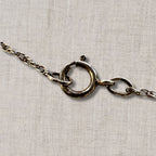 close up of sterling silver spring ring clasp on vintage necklace chain, secure closure detail for 18 inch coin pendant necklace, authentic silver chain hardware showing craftsmanship and wear consistent with vintage jewelry condition