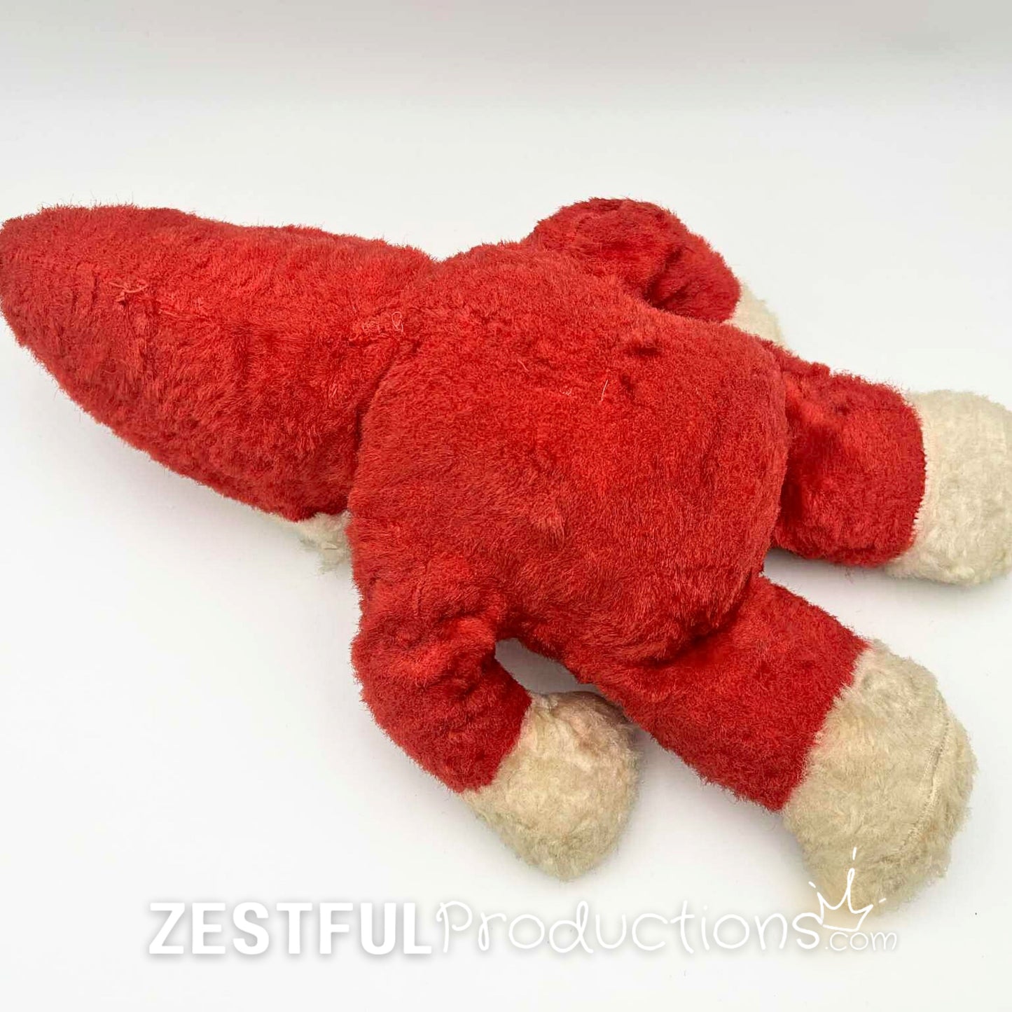 Rear flat lay view of vintage Santa Claus plush doll collectible in red plush suit with white trim. Mid century Rushton style Christmas toy perfect for retro holiday decor, nostalgic displays, and antique collectors.