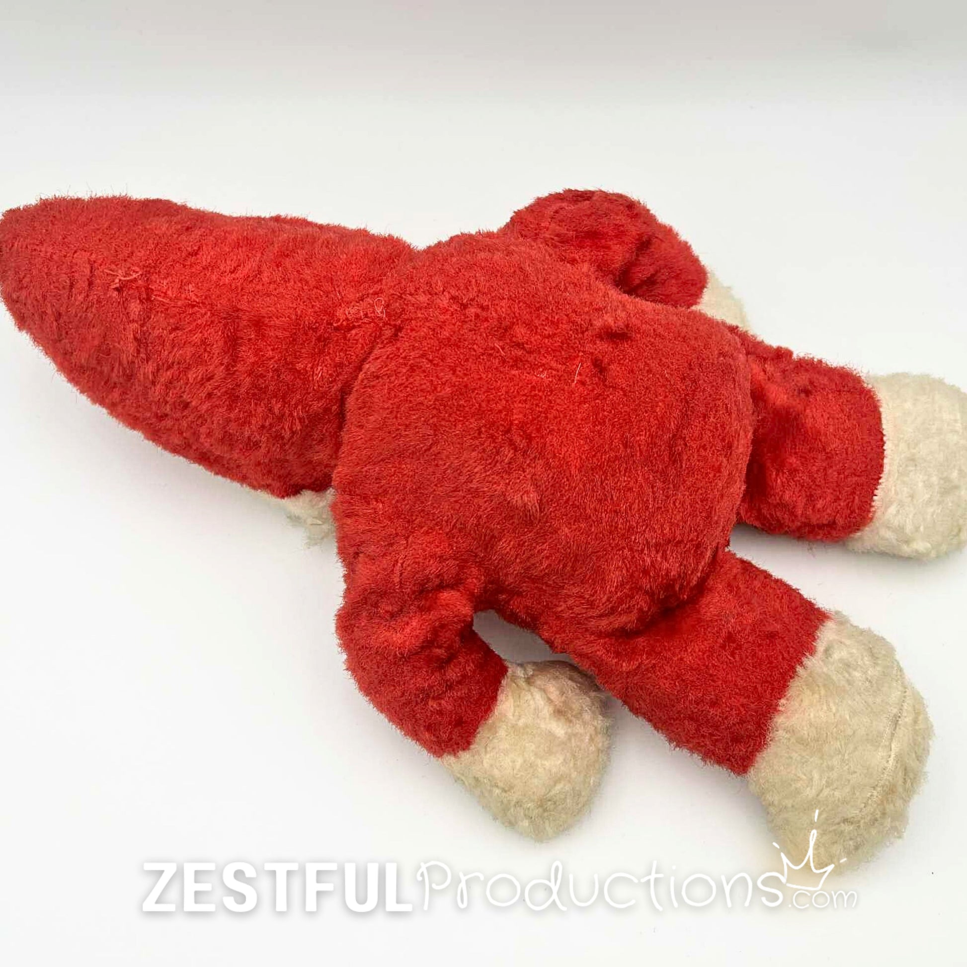 Rear flat lay view of vintage Santa Claus plush doll collectible in red plush suit with white trim. Mid century Rushton style Christmas toy perfect for retro holiday decor, nostalgic displays, and antique collectors.