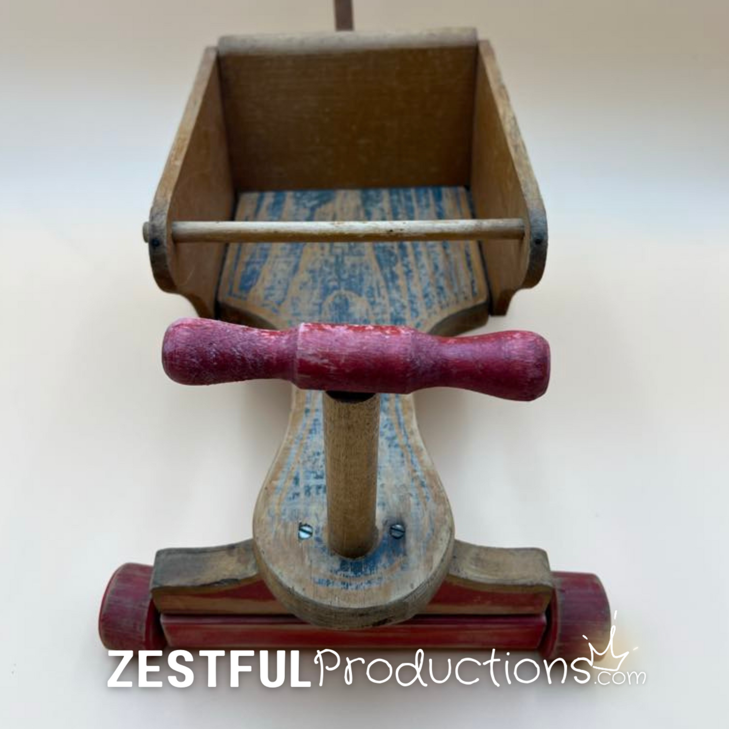 Angled view of mid-century wooden doll push toy