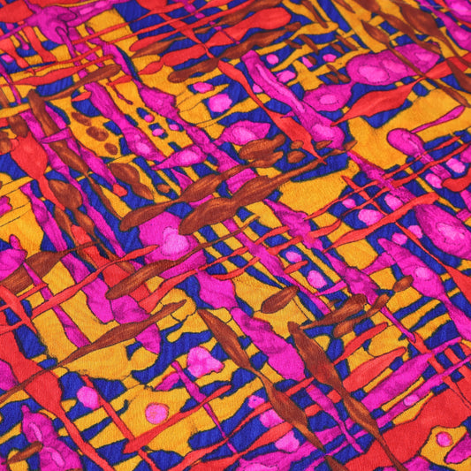 Vintage 1970s psychedelic curtain panels in bold pink, orange, and yellow abstract pattern shown flat to display full design.