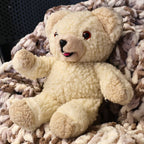 Authentic 1986 Lever Brothers Snuggle Bear plush photographed from an angled front view, highlighting its fluffy cream fur, raised arms, cheerful expression, and classic advertising mascot design. Perfect for vintage toy collectors, nostalgic displays, and cozy home decor.