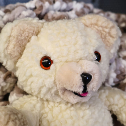 Vintage 1986 Snuggle Bear plush by Lever Brothers and Russ Berrie & Co. close-up showing its smiling face, cream sherpa plush, amber eyes, and original vintage character details. A nostalgic advertising collectible ideal for laundry room decor, vintage plush collections, and retro home decorating.