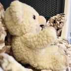 Side profile of an original 1986 Snuggle Bear plush by Lever Brothers and Russ Berrie, showcasing the soft sherpa-style texture, rounded ears, embroidered smile, and well-preserved vintage condition. A wonderful collectible for advertising enthusiasts and nursery decor.