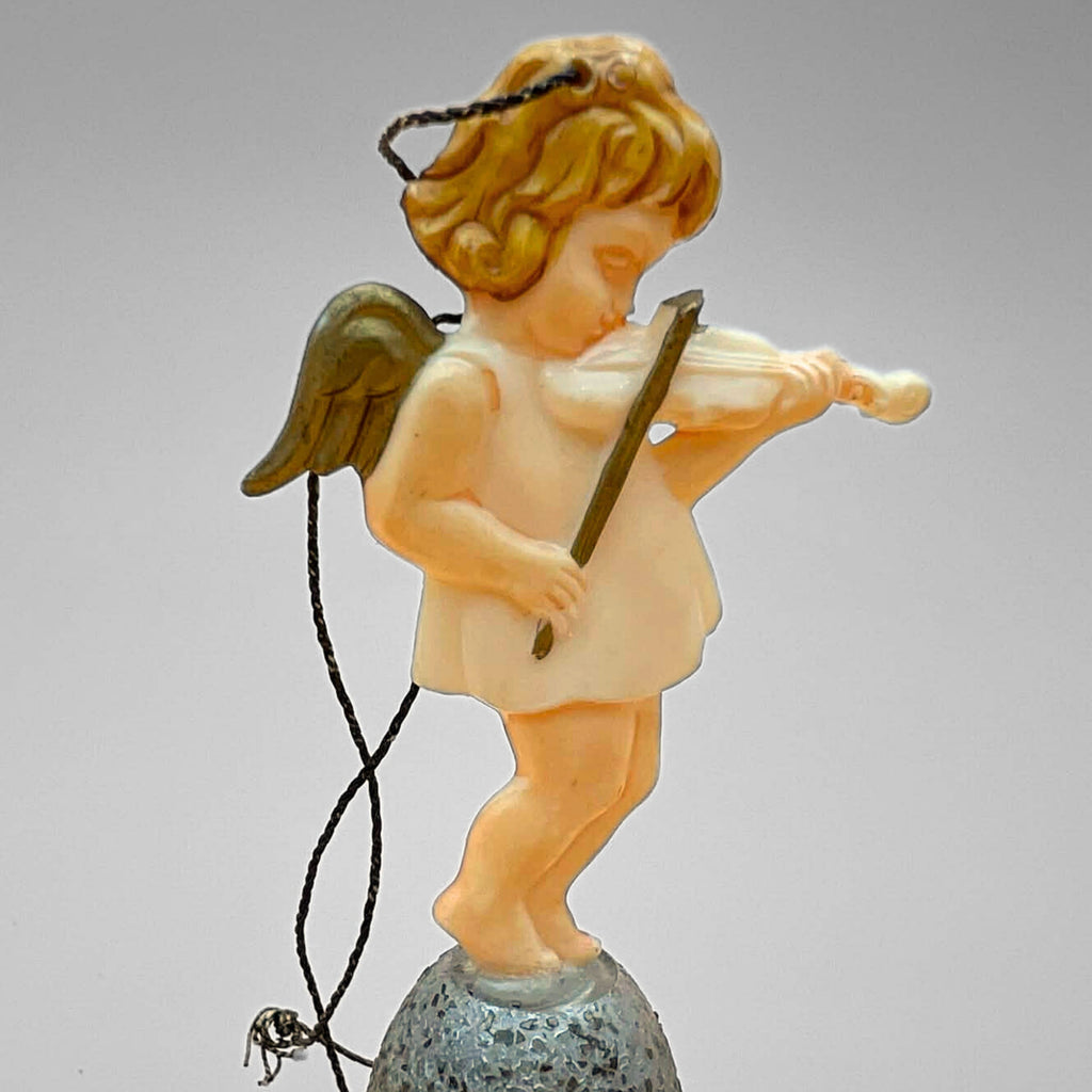 Single vintage angel bell ornament featuring cherub playing violin on a silver glitter bell. Side angle shows delicate instrument detail, wings, and original hanging string. Mid century West Germany Christmas collectible